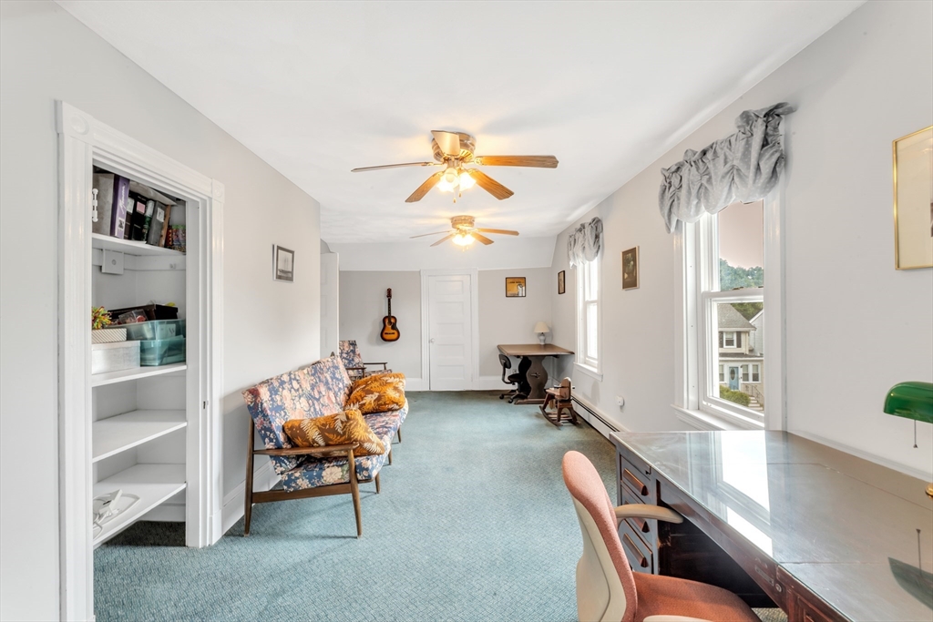 196 Maple Street Boston, MA 02132 - Photo 24 of 33 a living room with furniture a dining table and a chandelier