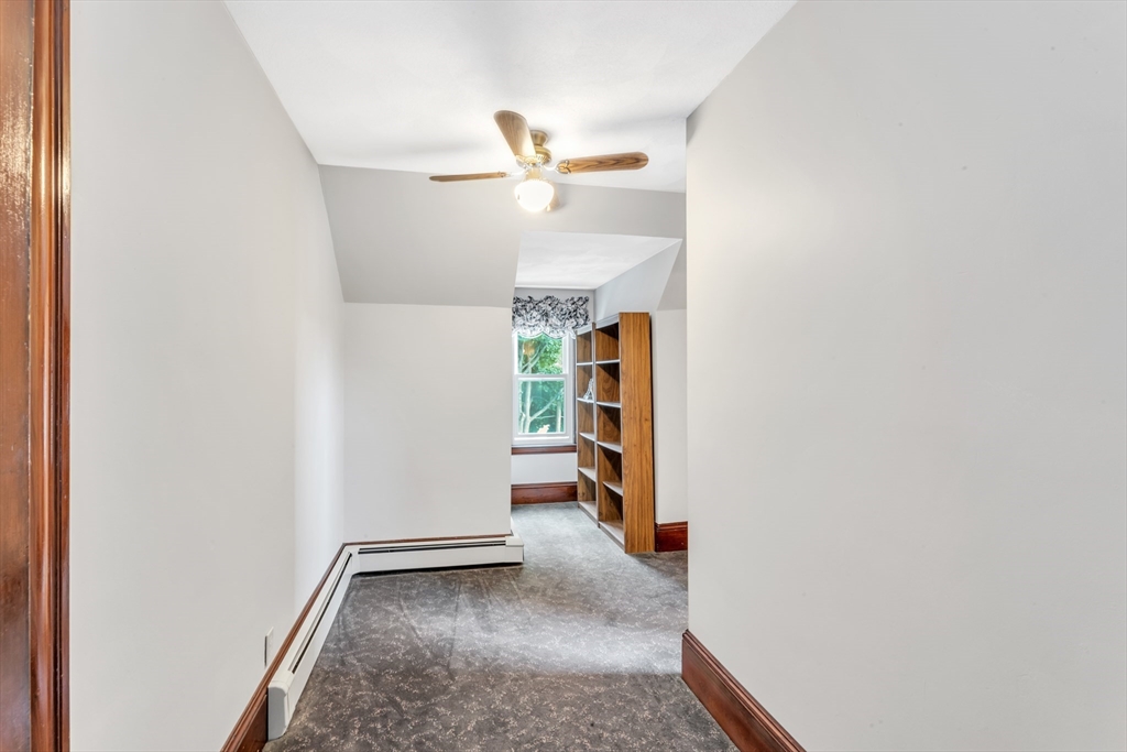 196 Maple Street Boston, MA 02132 - Photo 25 of 33 a view of hallway with stairs and a rug