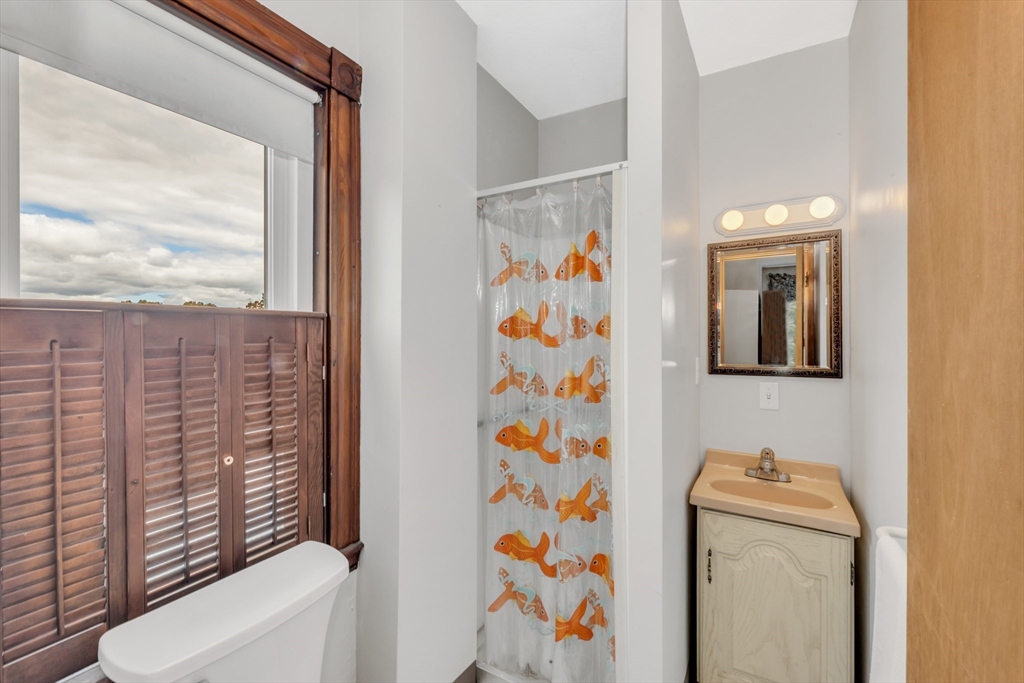 196 Maple Street Boston, MA 02132 - Photo 26 of 33 a bathroom with a toilet and a shower curtain