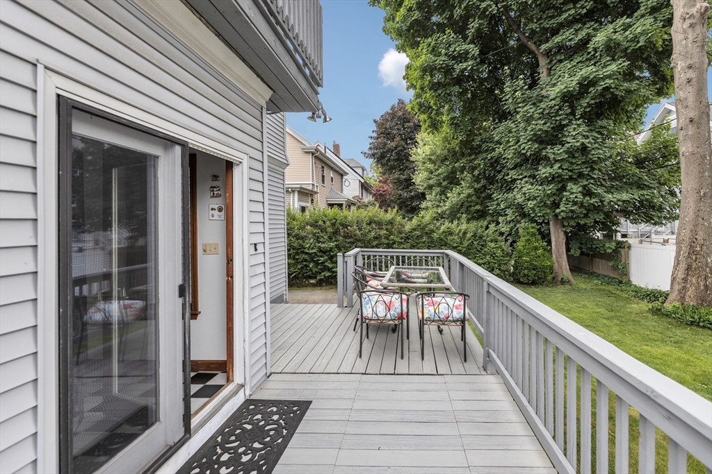 196 Maple Street Boston, MA 02132 - Photo 29 of 33 a view of balcony with wooden floor and bench