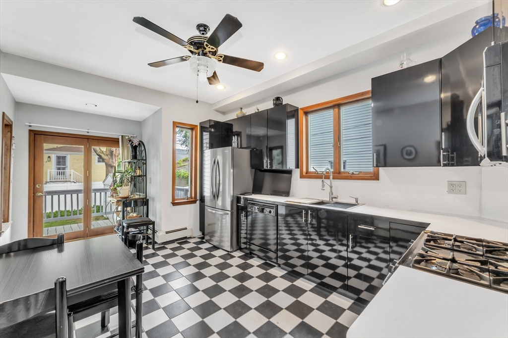 196 Maple Street Boston, MA 02132 - Photo 8 of 33 a living room with a black white checkered table and chairs with wooden floor