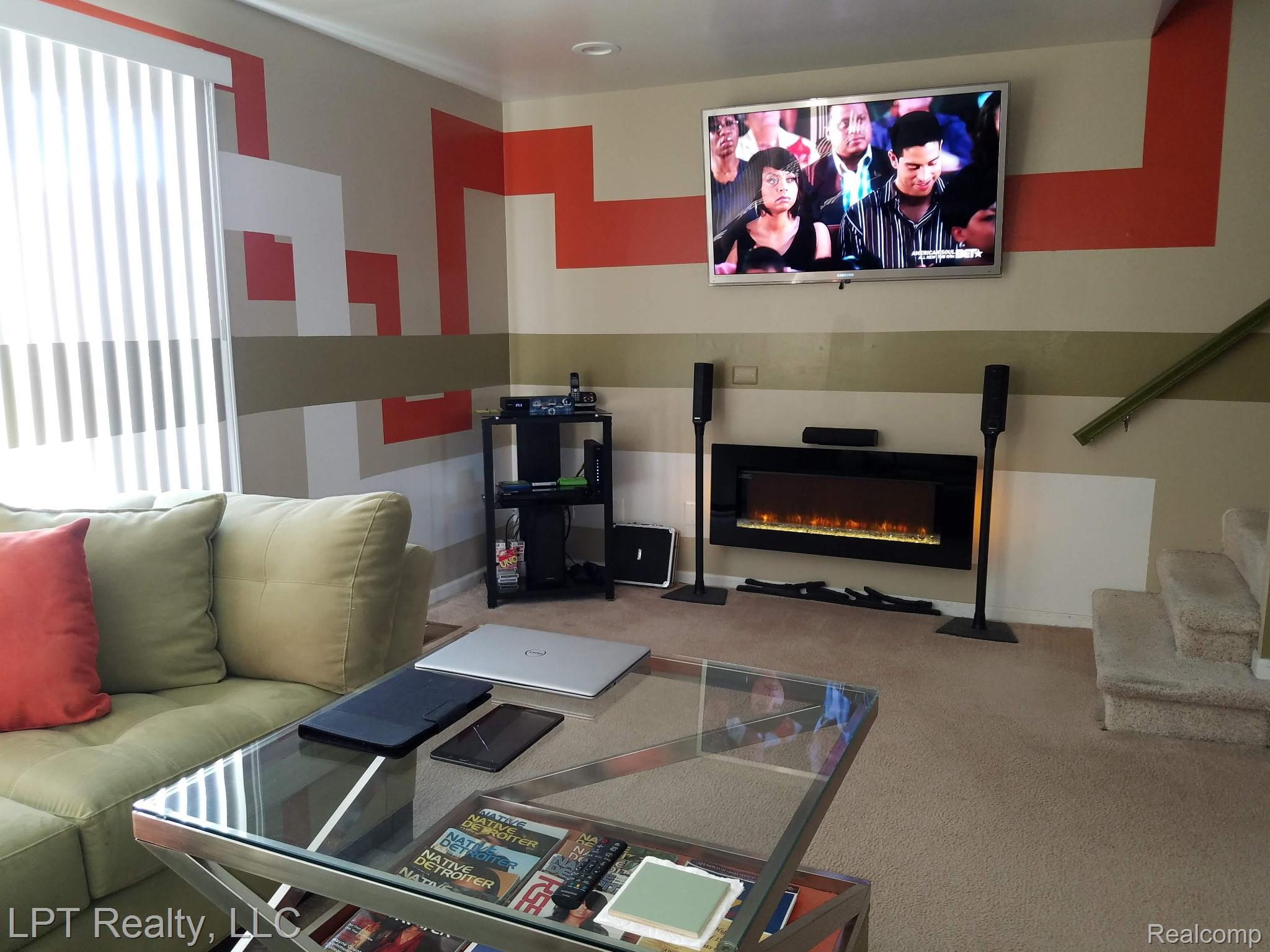 3304 Spinnaker Lane, Unit 47 Detroit, MI 48207 - Photo 3 of 21 Wall-mounted electric fireplace with a black finish