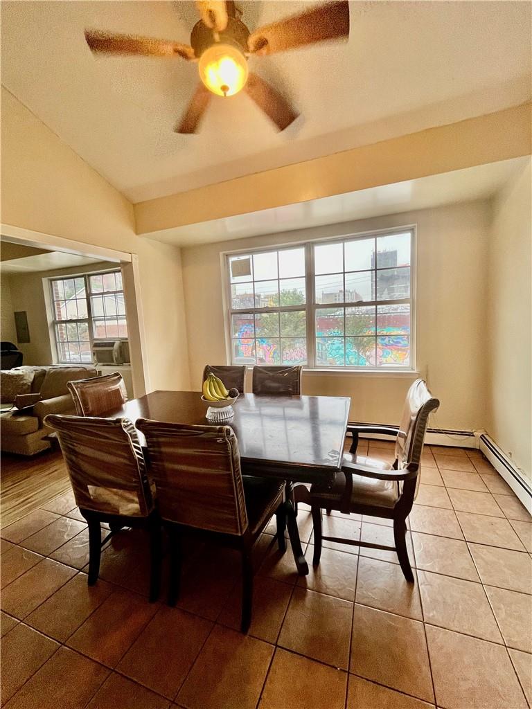 1012 East 172nd Street Bronx, NY 10460 - Photo 5 of 25 Dining room featuring a textured ceiling, cooling unit, lofted ceiling, tile patterned flooring, and ceiling fan
