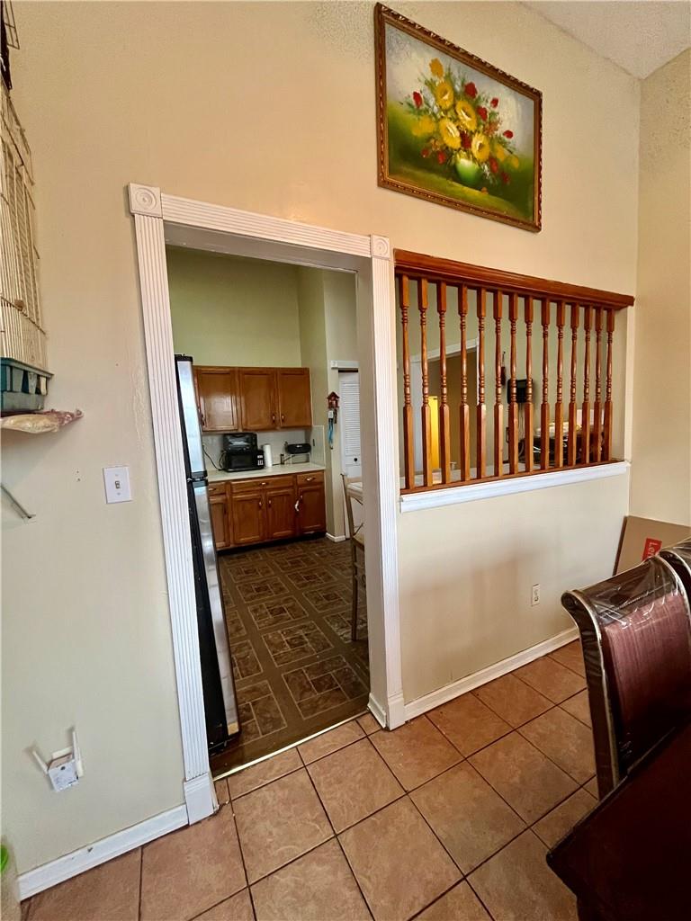 1012 East 172nd Street Bronx, NY 10460 - Photo 7 of 25 Kitchen with tile patterned floors and stainless steel fridge