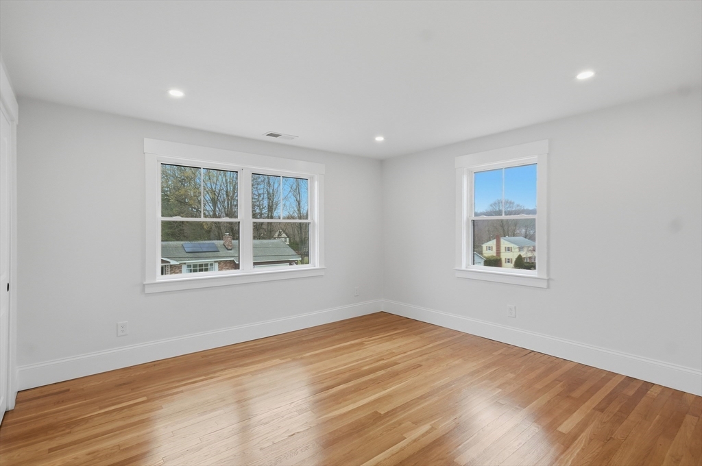 105 Stafford Road Lowell, MA 01852 - Photo 21 of 42 a view of an empty room with wooden floor and a window