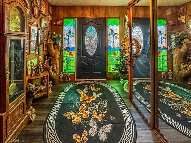a living room with furniture a flat screen tv and gym equipment