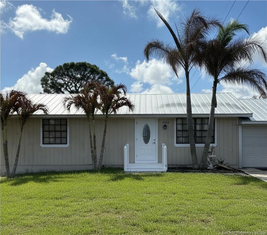 a view of a house with a backyard