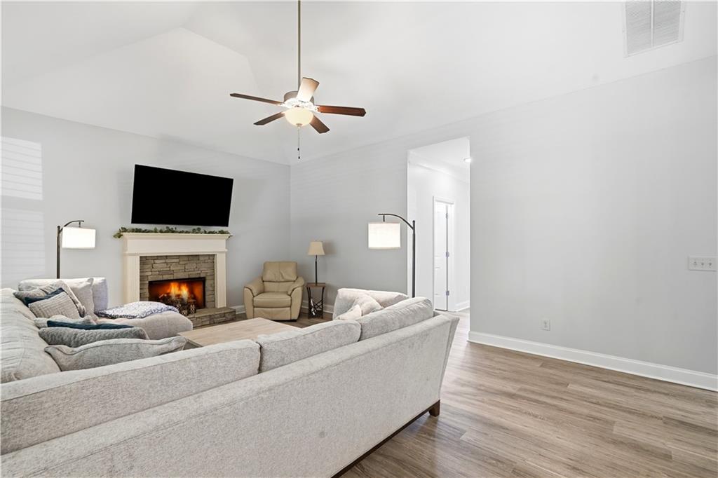 302 Spence Circle Ball Ground, GA 30107 - Photo 9 of 55 a living room with furniture a fireplace and a flat screen tv