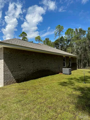a view of house with backyard space and garden