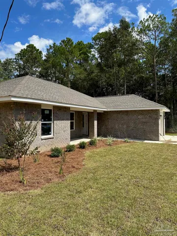 a house that has a tree in front of it
