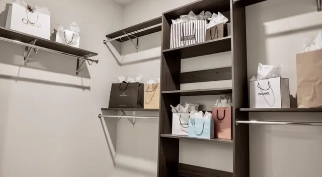 a view of walk in closet with clothes and shoes