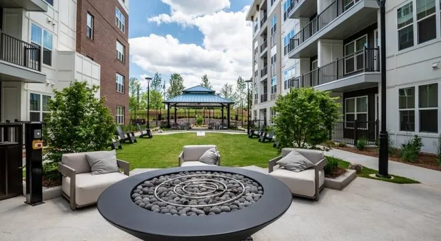 a view of a patio with couches table and chairs and potted plants