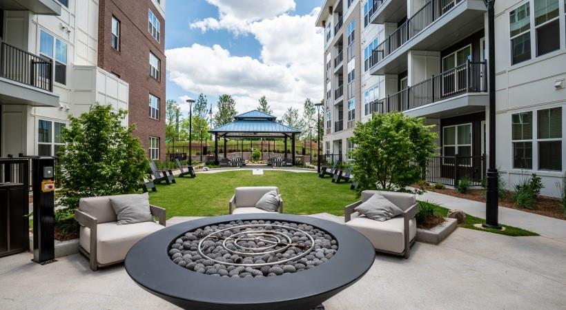 800 Galleria Parkway Southeast, Unit 457 Atlanta, GA 30339 - Photo 17 of 35 a view of a patio with couches table and chairs and potted plants