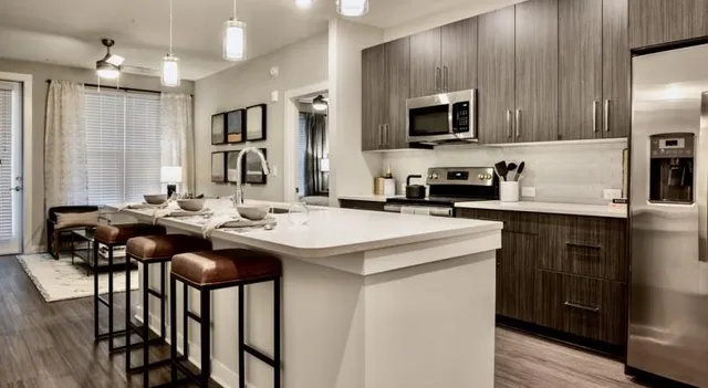 a kitchen with sink cabinets and stainless steel appliances