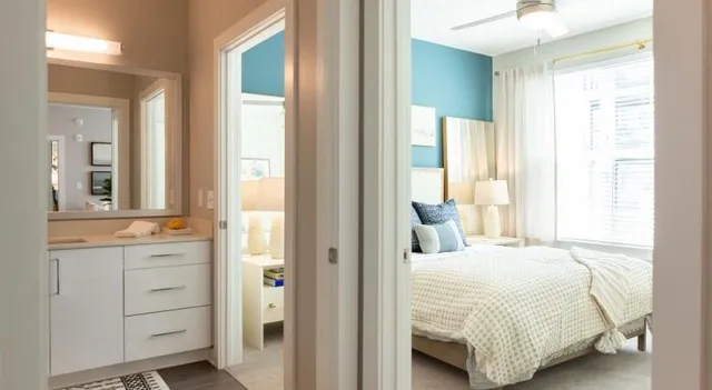 a bedroom with a bed and a mirror