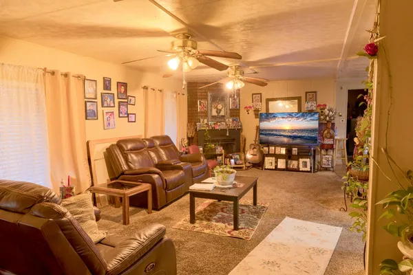 a living room with furniture and a chandelier