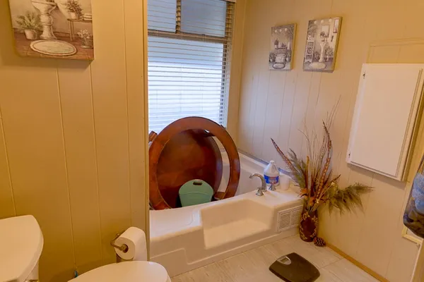 a bed room with a bed and a chair