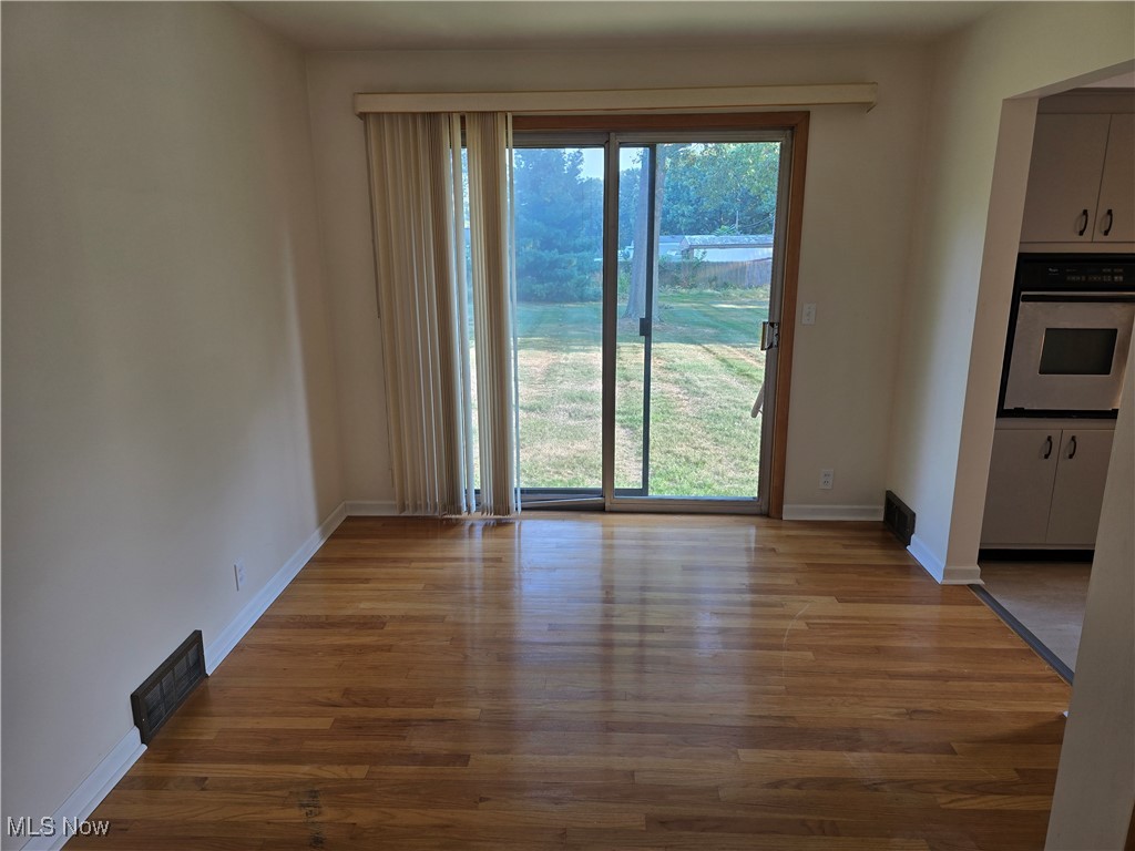 67 Moore Road Akron, OH 44319 - Photo 5 of 15 Unfurnished dining area featuring wood-type flooring