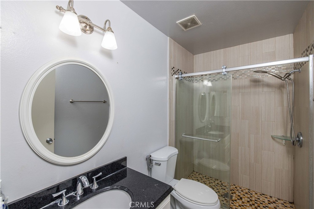 12279 Westcliff Drive Stanton, CA 90680 - Photo 18 of 26 a bathroom with a sink mirror toilet and shower