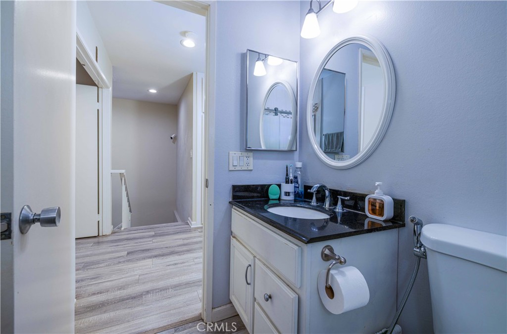 12279 Westcliff Drive Stanton, CA 90680 - Photo 24 of 26 a bathroom with a granite countertop double vanity sink and a mirror