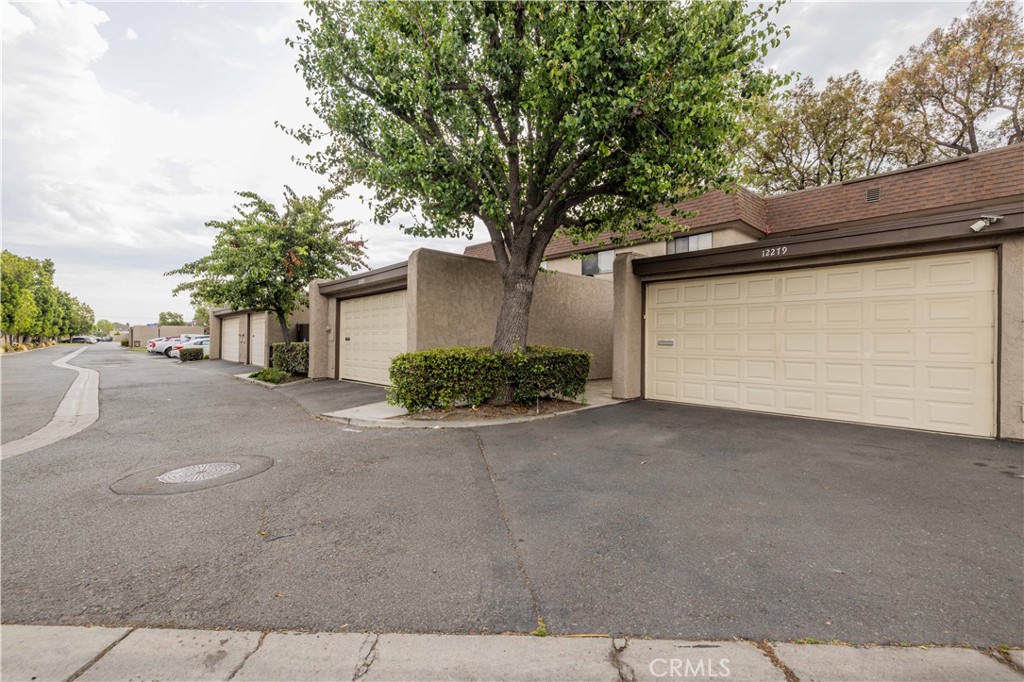 12279 Westcliff Drive Stanton, CA 90680 - Photo 5 of 26 a front view of a house with a yard and garage