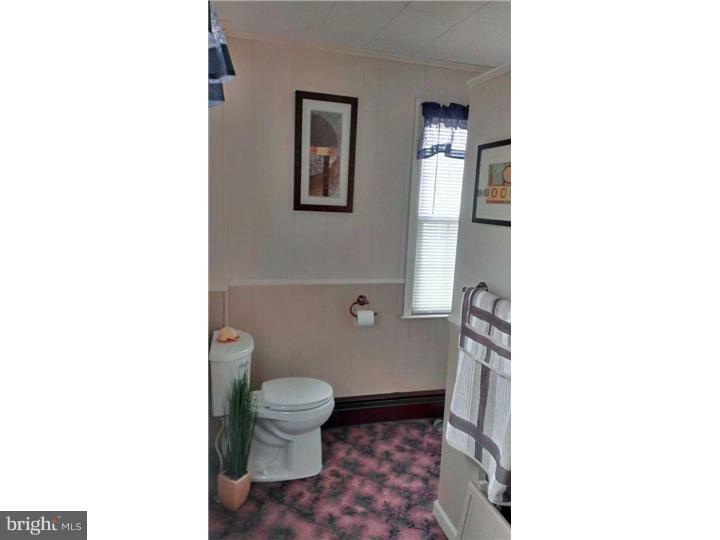 731 Iszard Road Deptford, NJ 08096 - Photo 4 of 20 a bathroom with a toilet a sink and mirror