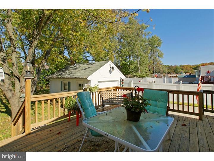 731 Iszard Road Deptford, NJ 08096 - Photo 6 of 20 a view of a chairs and table on the wooden deck