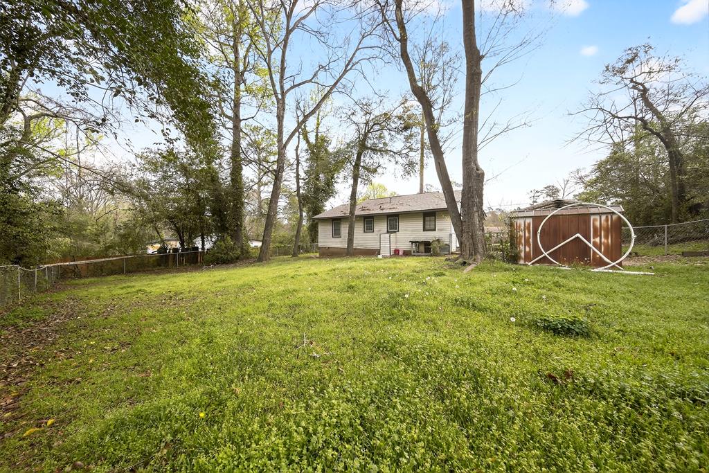 2963 Grant Road Columbus, GA 31907 - Photo 14 of 15 a backyard of a house with lots of green space