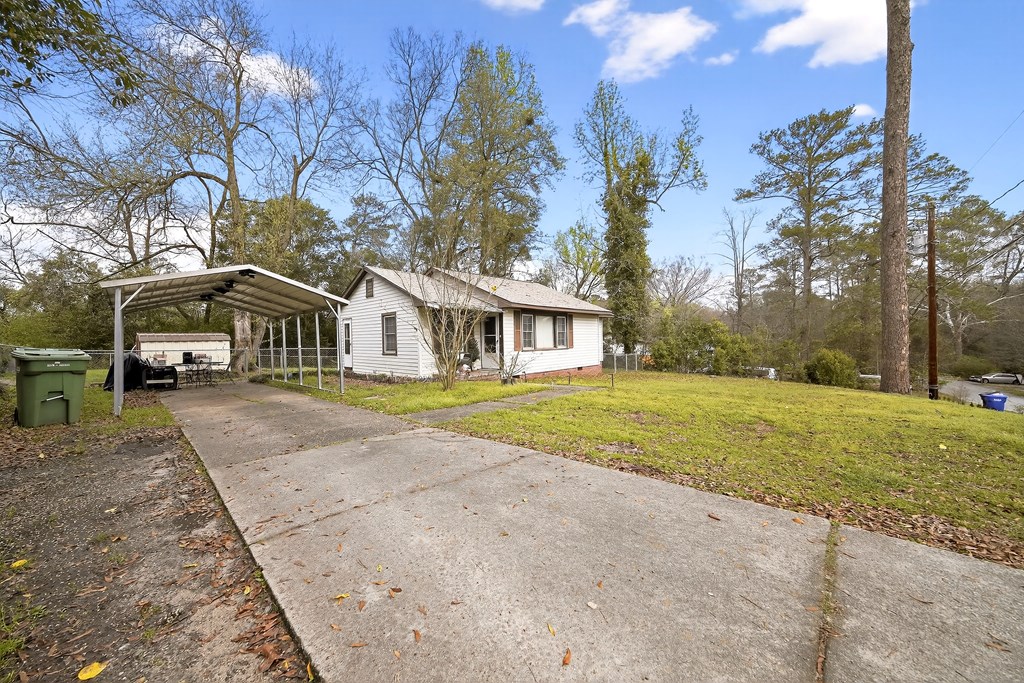 2963 Grant Road Columbus, GA 31907 - Photo 4 of 15 a yellow house with trees in front of it