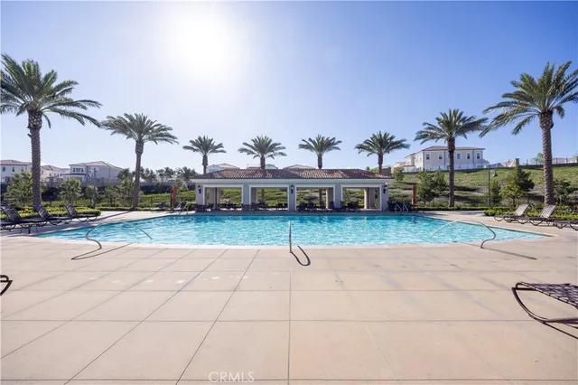 a swimming pool with outdoor seating and yard