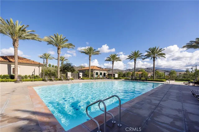 a view of a swimming pool with lounge chairs