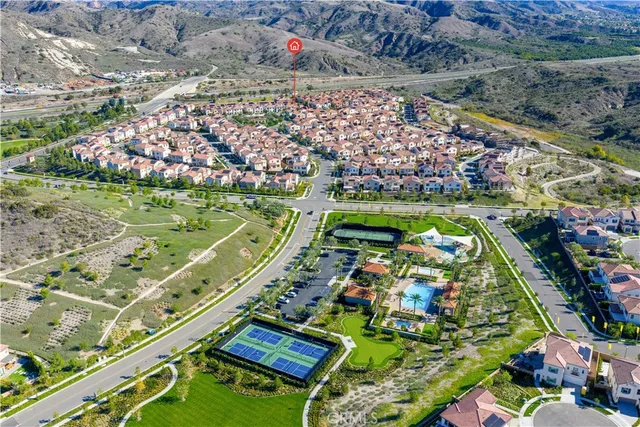 an aerial view of residential houses with outdoor space and swimming pool