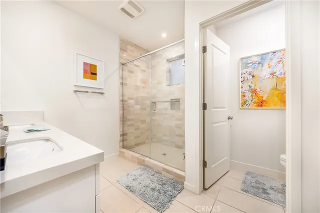 a bathroom with a shower and sink