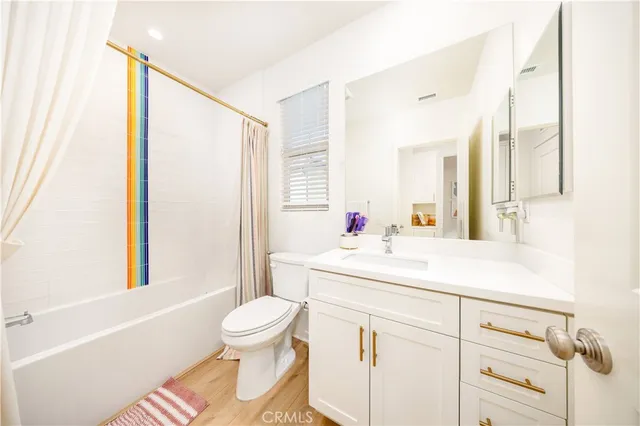 a bathroom with a sink a toilet and a large mirror