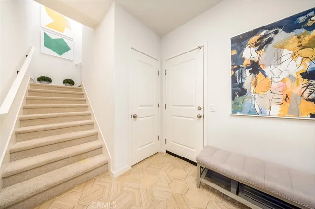 a view of a bedroom with wooden floor and windows