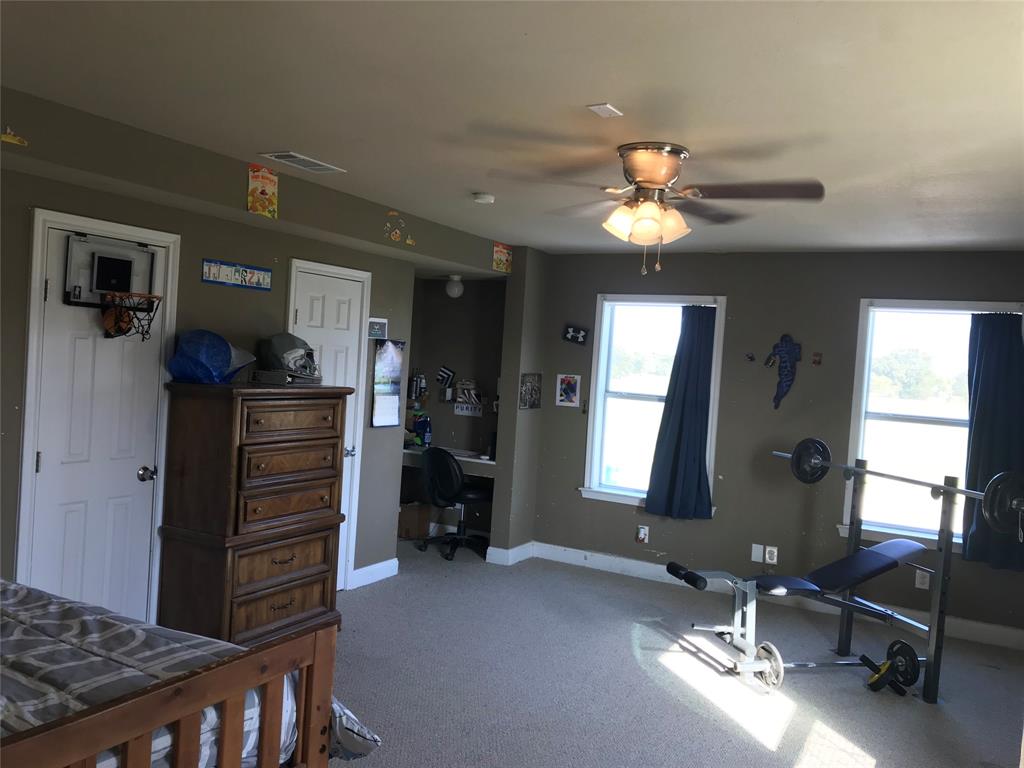 1100 East Rabbit Cove Road Quinlan, TX 75474 - Photo 12 of 18 Carpeted bedroom with an office area and ceiling fan