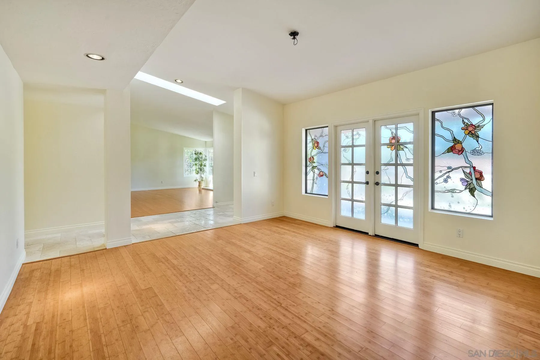 13145 Silver Saddle Lane Poway, CA 92064 - Photo 13 of 53 an empty room with wooden floor and windows