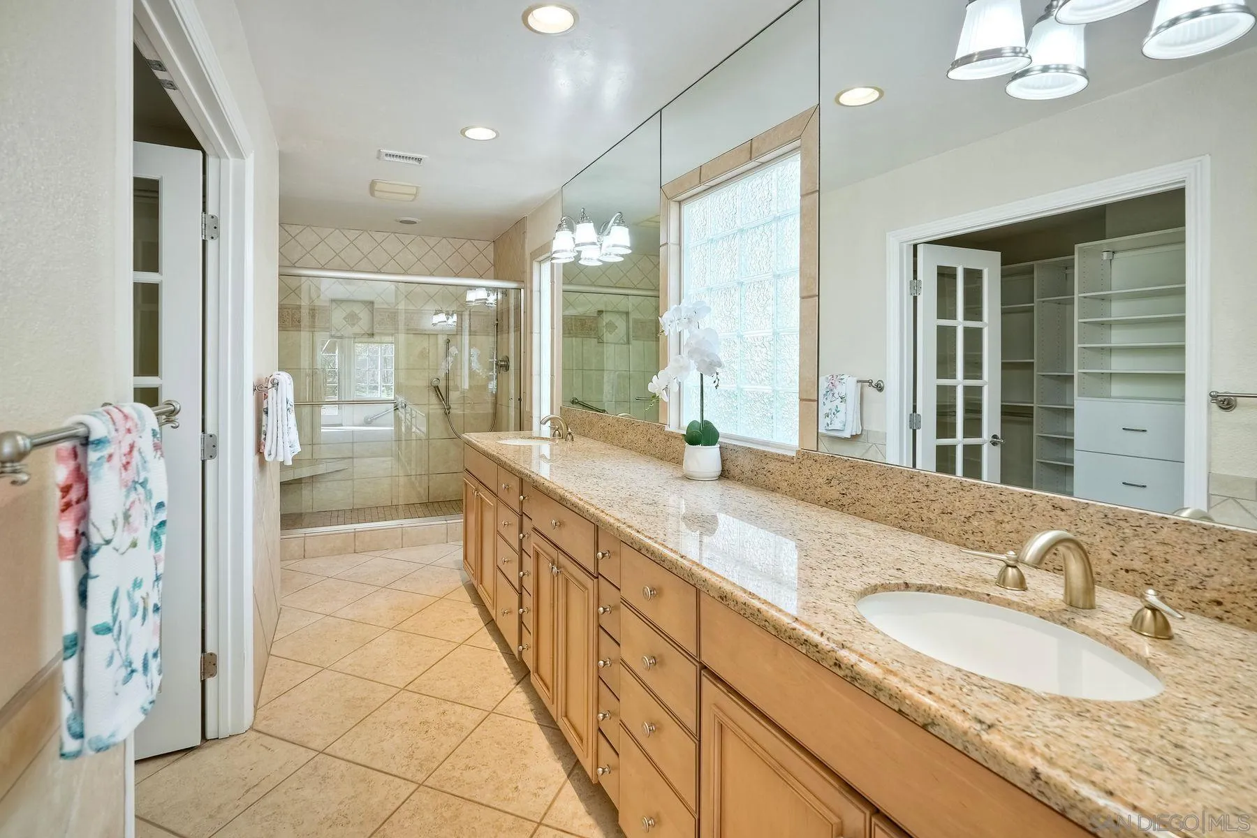 13145 Silver Saddle Lane Poway, CA 92064 - Photo 17 of 53 a bathroom with a granite countertop sink mirror and shower