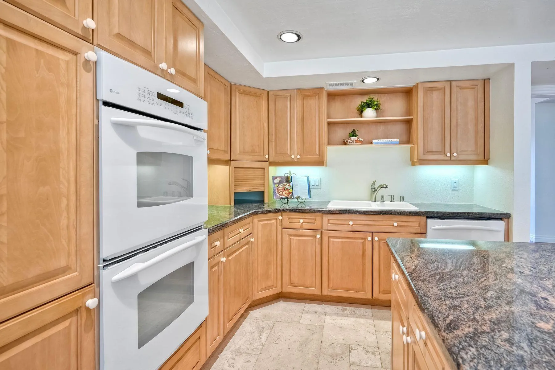 13145 Silver Saddle Lane Poway, CA 92064 - Photo 23 of 53 a kitchen with granite countertop cabinets stainless steel appliances and a counter space