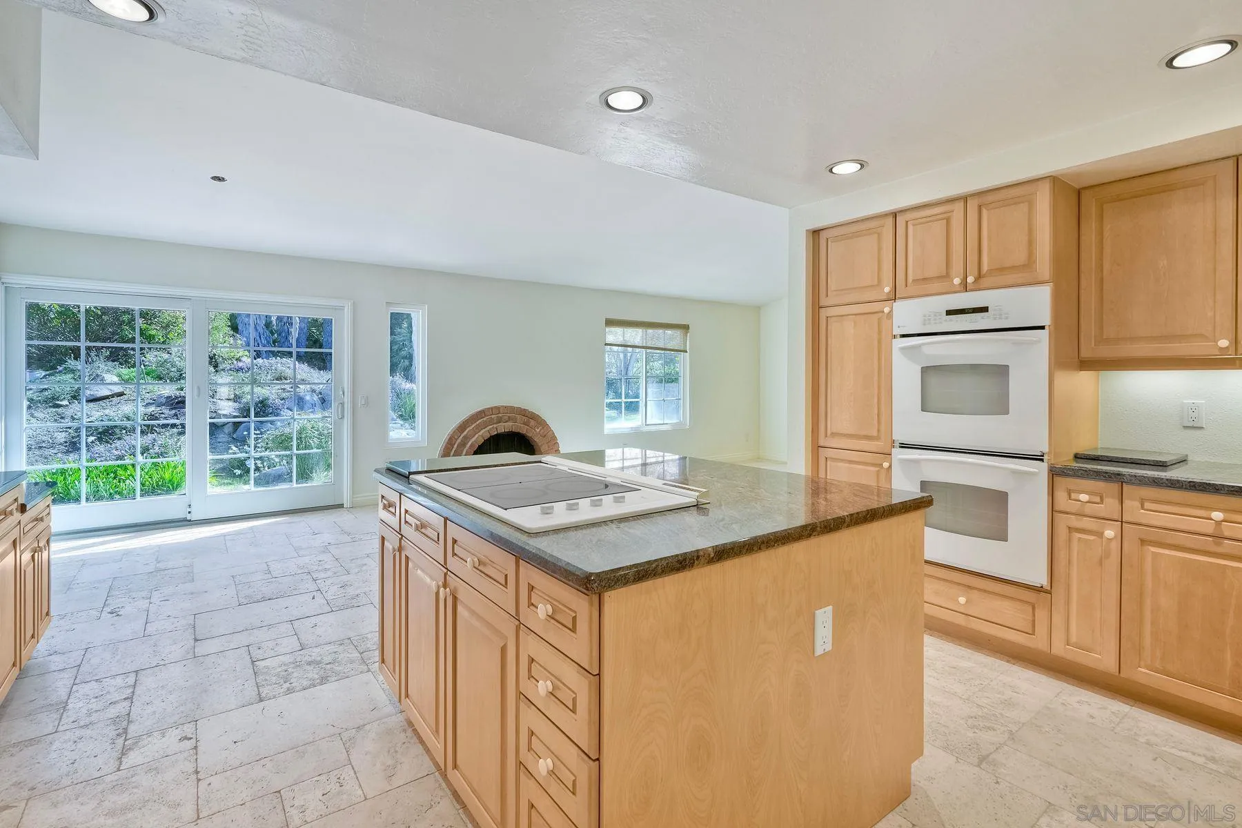 13145 Silver Saddle Lane Poway, CA 92064 - Photo 24 of 53 a kitchen with kitchen island granite countertop a stove and a sink