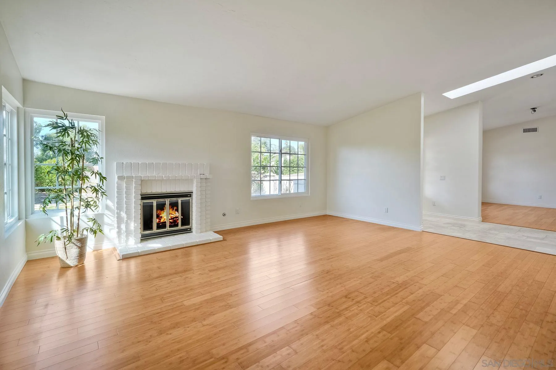 13145 Silver Saddle Lane Poway, CA 92064 - Photo 7 of 53 a view of an empty room with window and wooden floor