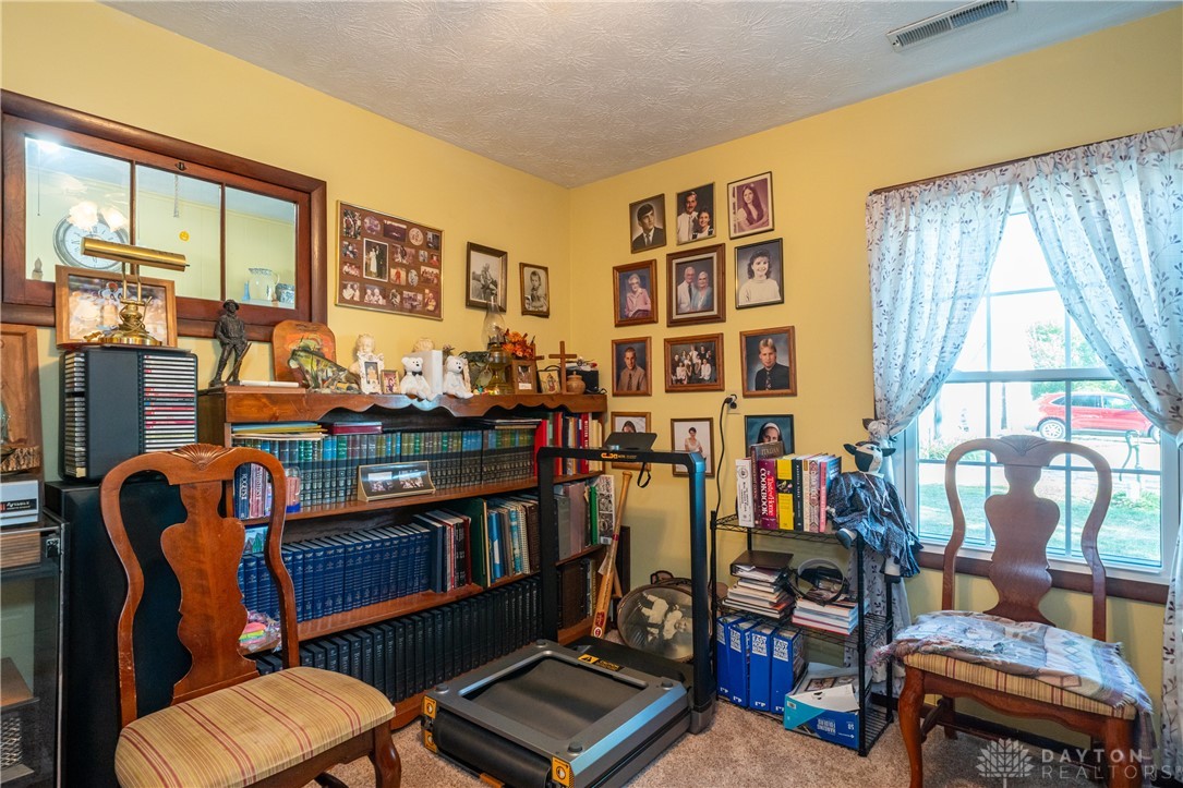 1599 Garringer Road Jamestown, OH 45335 - Photo 27 of 73 This cozy room features ample natural light and a built-in bookshelf for organized living.