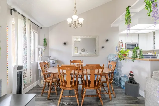 a view of a dining room with furniture and a chandelier