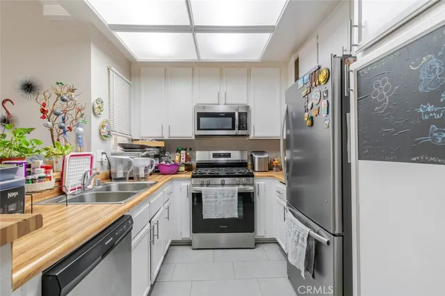 a kitchen with granite countertop stainless steel appliances and a counter space