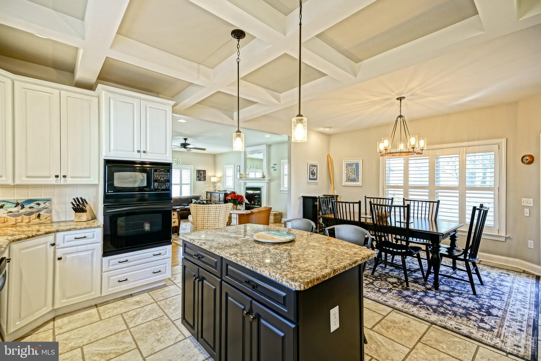 412 Mulberry Street Lewes, DE 19958 - Photo 16 of 74 a kitchen with granite countertop a stove a sink a dining table and chairs with wooden floor