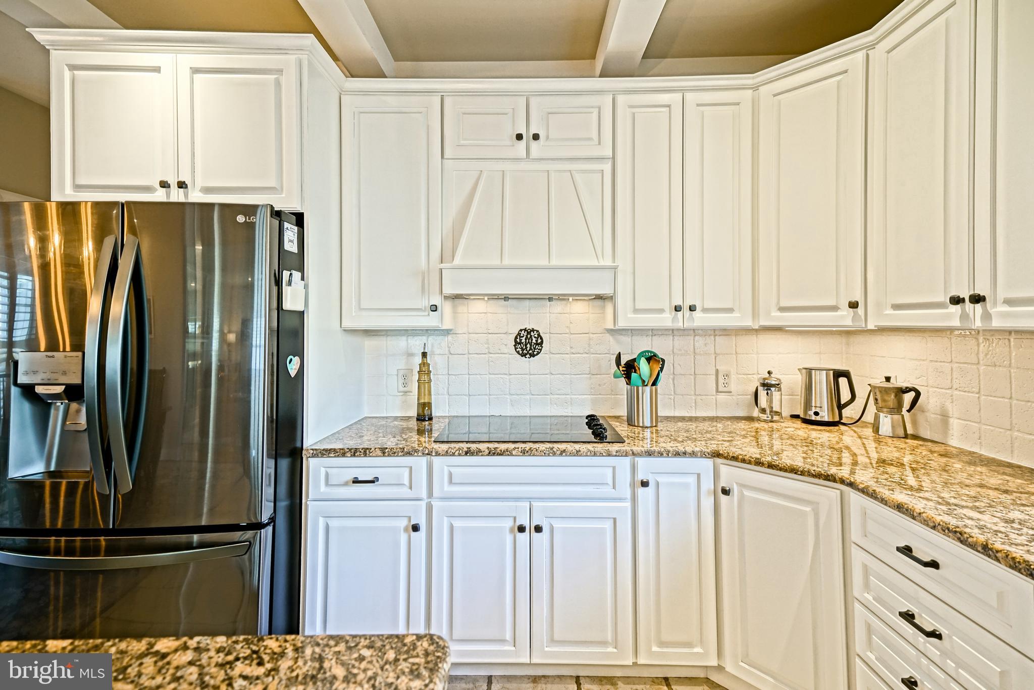 412 Mulberry Street Lewes, DE 19958 - Photo 18 of 74 a kitchen with granite countertop a refrigerator sink and cabinets