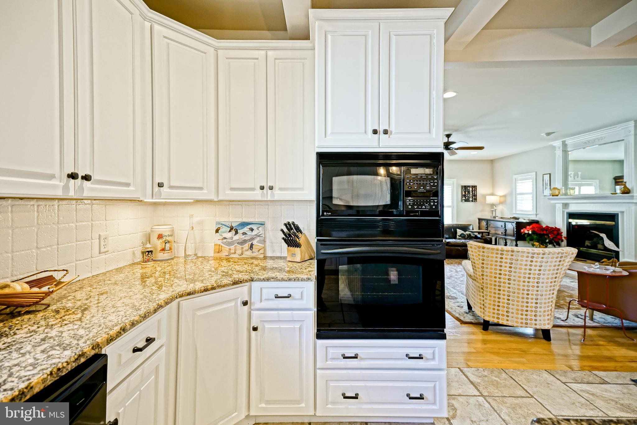 412 Mulberry Street Lewes, DE 19958 - Photo 19 of 74 a kitchen with granite countertop a stove a sink and a white cabinets