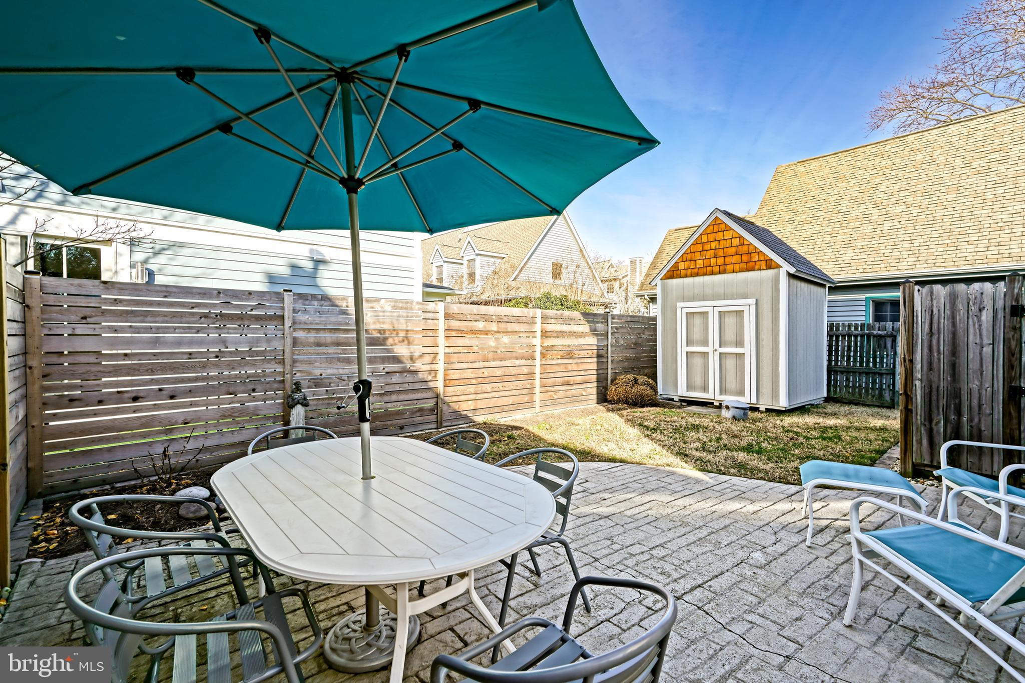 412 Mulberry Street Lewes, DE 19958 - Photo 66 of 74 a backyard of a house with table and chairs