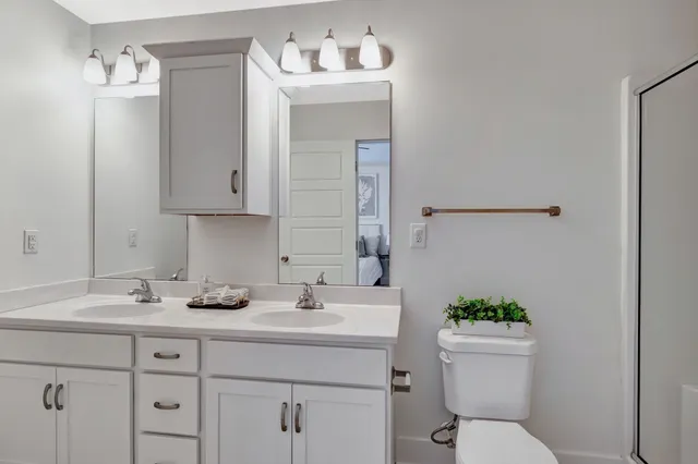 a bathroom with a sink toilet and mirror