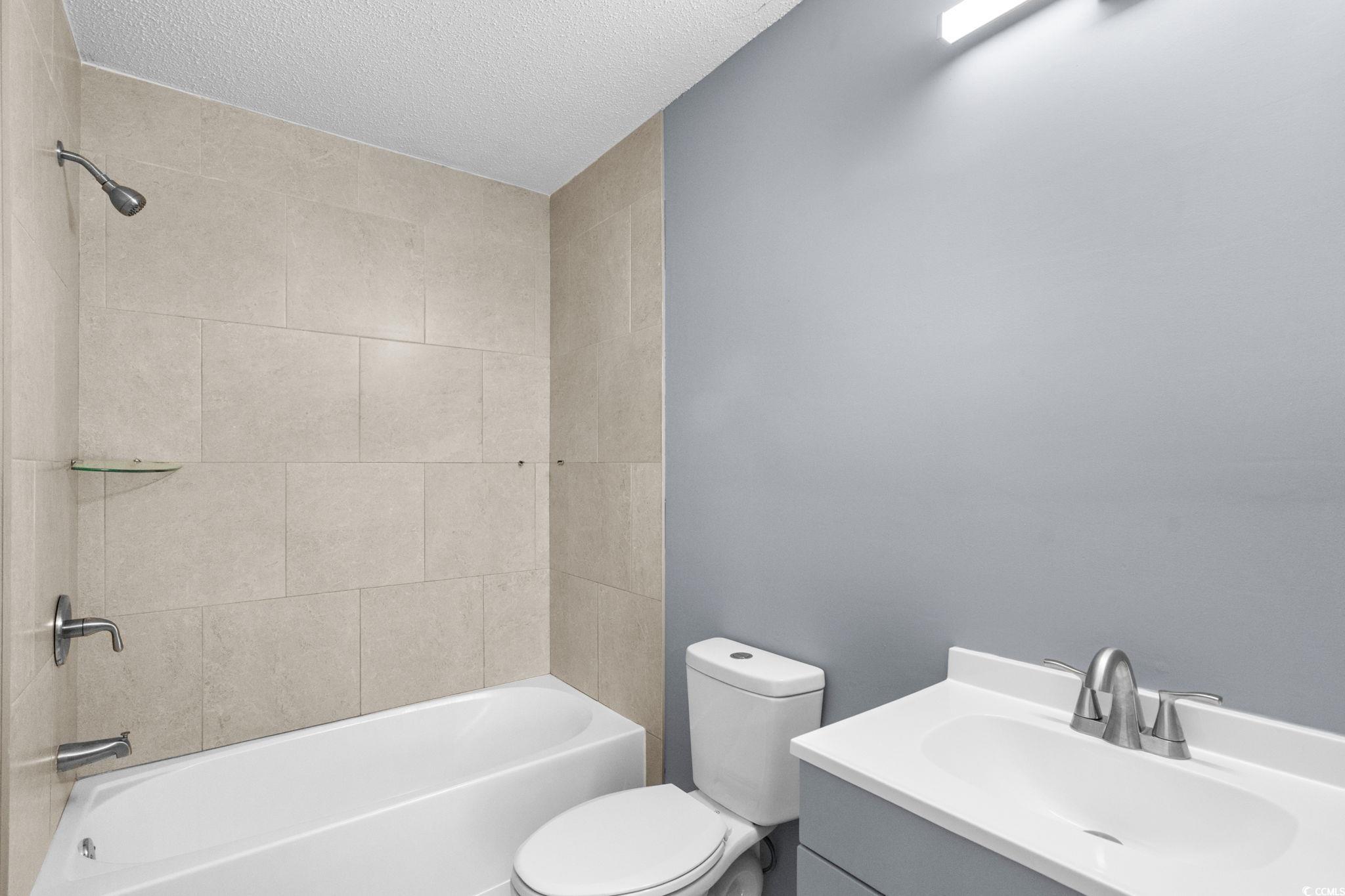 3343 New Road Conway, SC 29527 - Photo 18 of 36 Bathroom featuring vanity, shower / bathtub combination, and a textured ceiling